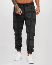 Dean | Comfortabele geruite joggingbroek in de kleur Zwart voor heren in Lounge stijl ideaal voor de herfst.