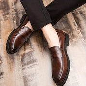 Heren Penny Loafers met brogue details. Deze tijdloze loafers bieden duurzaamheid en een klassieke uitstraling met hun PU-lederen bovenwerk. De slijtvaste eigenschappen zorgen voor comfort en betrouwbaarheid, terwijl het instapontwerp het gemak van aantrekken biedt. Ideaal voor zowel zakelijke als feestelijke gelegenheden.