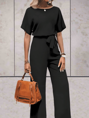 Paige | Effen jumpsuit met korte wijde mouwen en striklinten in de kleur Zwart voor dames in stijl ideaal voor de zomer.
