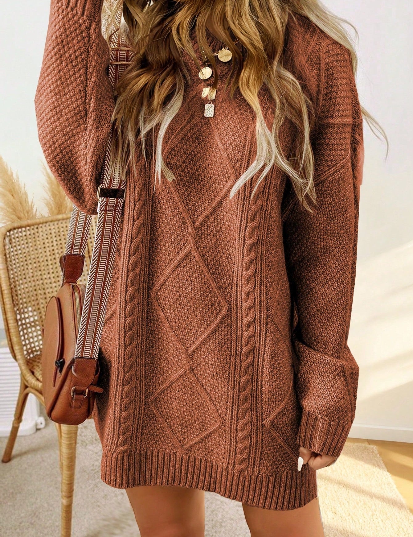 Trui jurk met kabelpatroon en ribbelafwerking