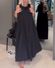Elegante mouwloze jurk in effen kleur met een omslag in de kleur Zwart voor dames in stijl ideaal voor de lente.